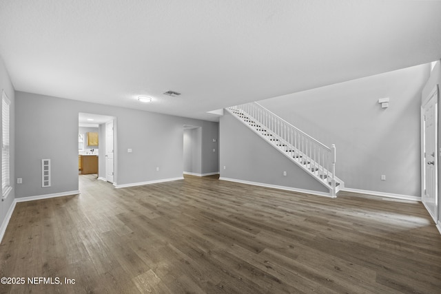 unfurnished living room with dark wood-type flooring