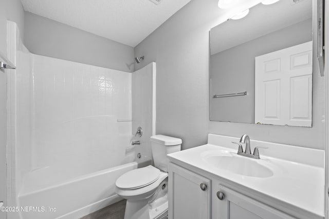 full bathroom featuring vanity, shower / bath combination, a textured ceiling, and toilet