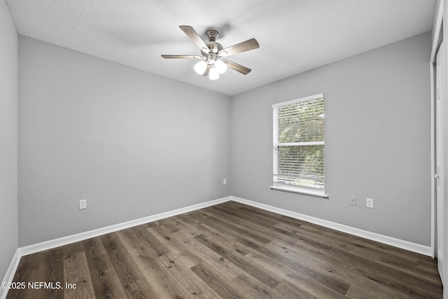 empty room featuring a textured ceiling, dark hardwood / wood-style flooring, and ceiling fan