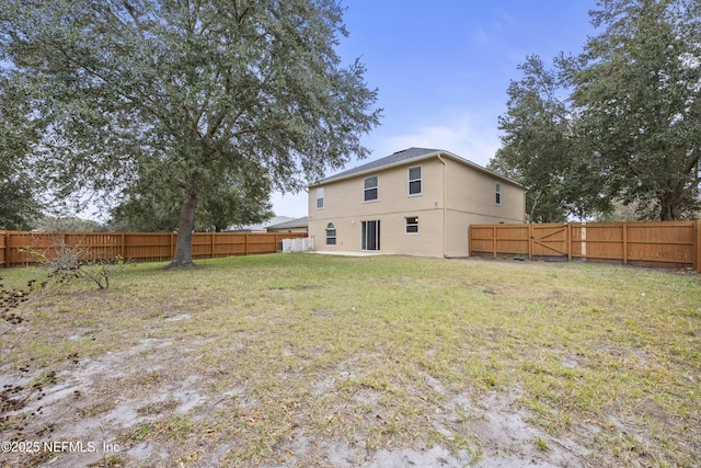 rear view of house with a yard