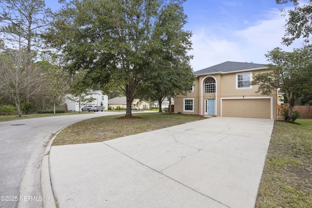 view of front of home featuring a front yard and a garage