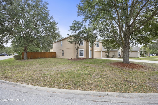 view of front of home featuring a front lawn and a garage