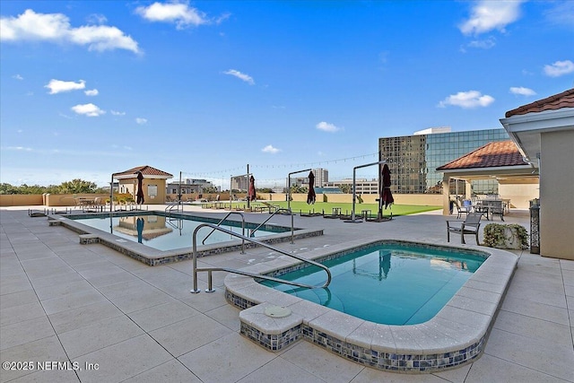 view of pool with a patio area and a jacuzzi