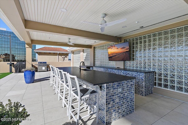 view of patio / terrace with ceiling fan and an outdoor wet bar