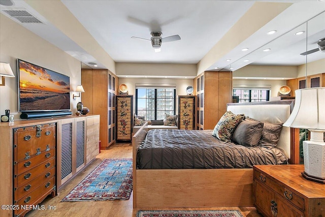 bedroom with ceiling fan and light wood-type flooring