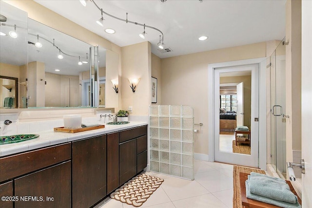 bathroom featuring tile patterned floors, vanity, and walk in shower