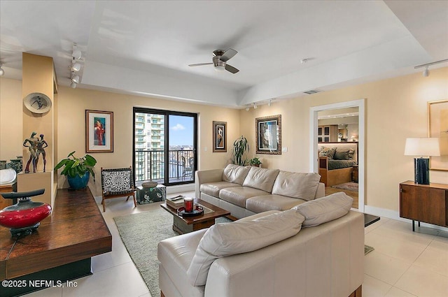 tiled living room featuring ceiling fan and rail lighting