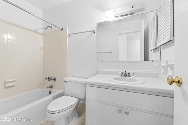 full bathroom featuring toilet, tiled shower / bath, and vanity