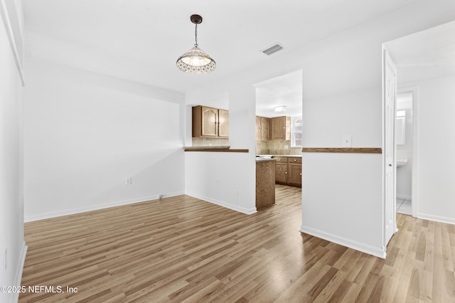 unfurnished living room with light hardwood / wood-style flooring