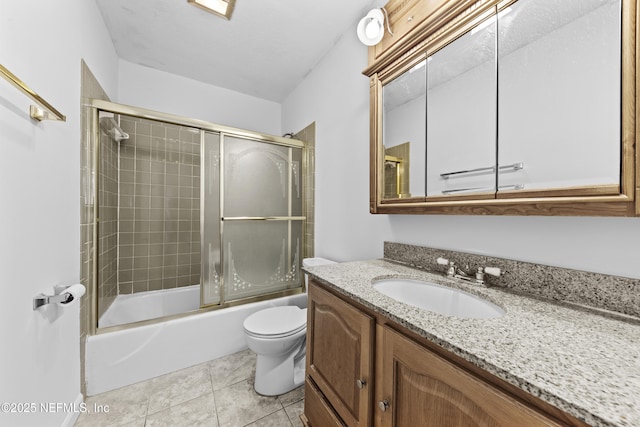 full bathroom with toilet, vanity, tile patterned flooring, and shower / bath combination with glass door