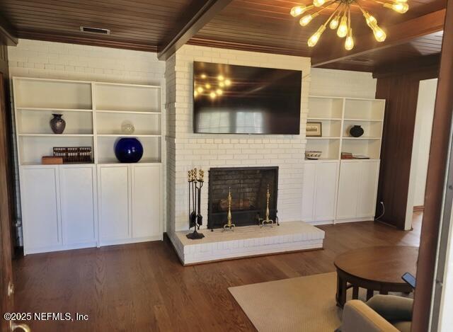 living room with wooden ceiling, dark wood-type flooring, a fireplace, beam ceiling, and built in features