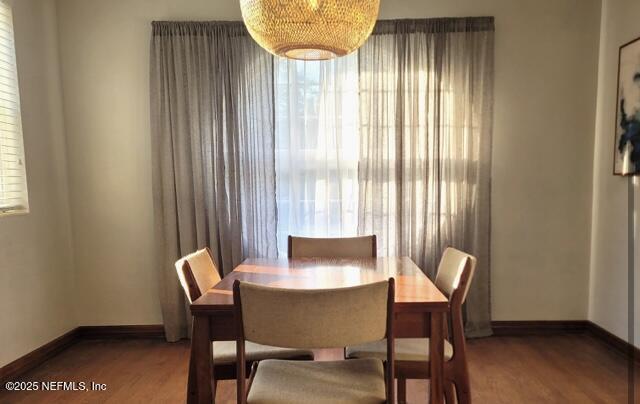 dining space with wood-type flooring and plenty of natural light