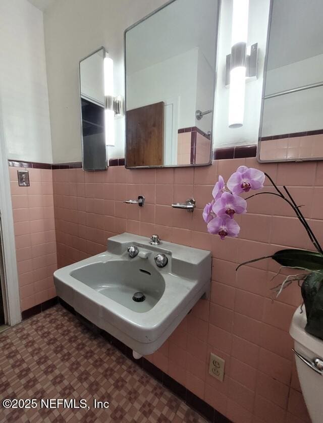 bathroom with tile walls