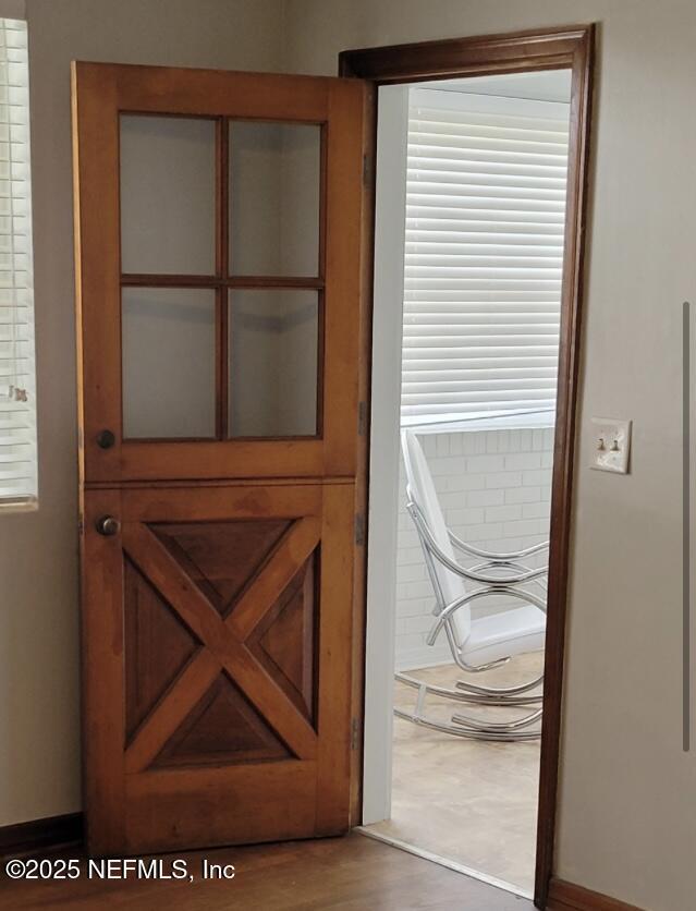 doorway with hardwood / wood-style flooring