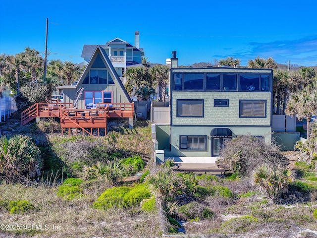 rear view of house featuring a deck