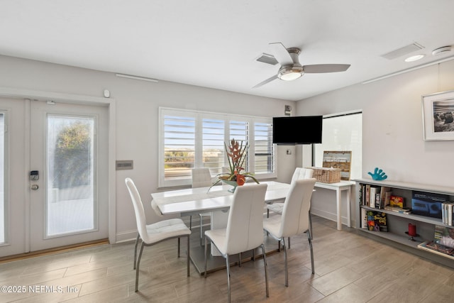 dining space with hardwood / wood-style flooring and ceiling fan