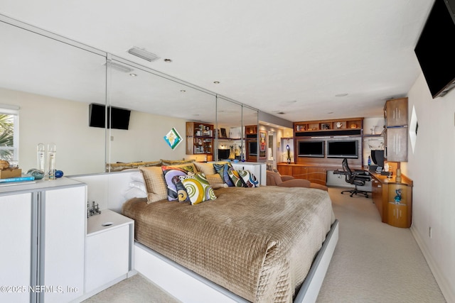 bedroom featuring light colored carpet