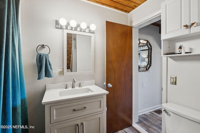 bathroom with vanity, hardwood / wood-style floors, and toilet