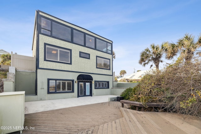 back of house with a wooden deck