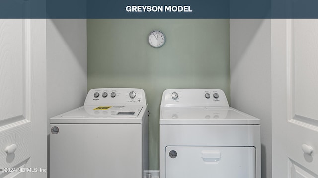 clothes washing area with washing machine and dryer