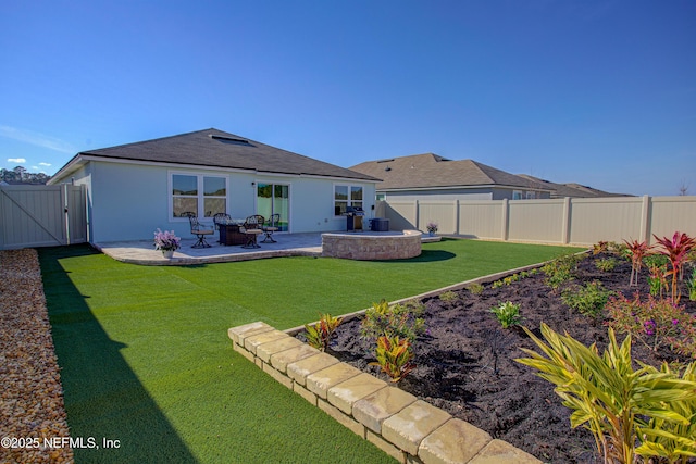 rear view of house with a patio area and a lawn