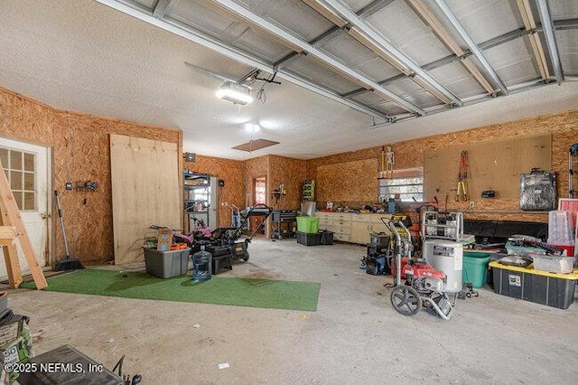 garage with a garage door opener and a workshop area