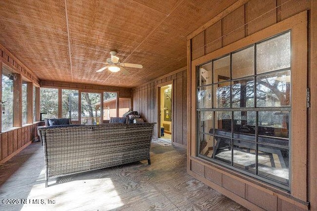 sunroom / solarium with plenty of natural light, wooden ceiling, and ceiling fan