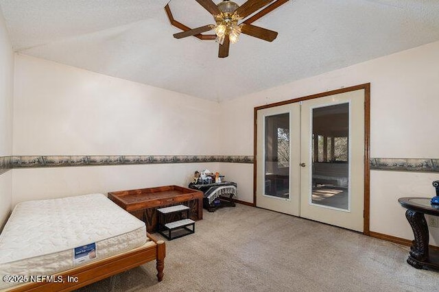 carpeted bedroom featuring ceiling fan, access to exterior, a textured ceiling, vaulted ceiling, and french doors