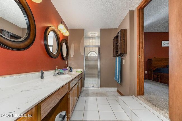 bathroom with vanity, tile patterned floors, and a textured ceiling