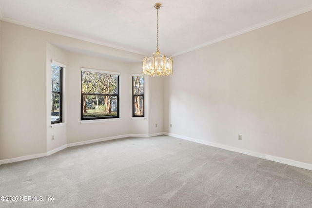 spare room featuring ornamental molding, a chandelier, and carpet flooring