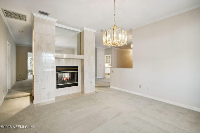 unfurnished living room with ornamental molding, a fireplace, a chandelier, and carpet