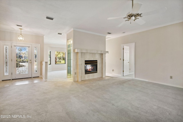 unfurnished living room with ceiling fan, light colored carpet, ornamental molding, and a high end fireplace