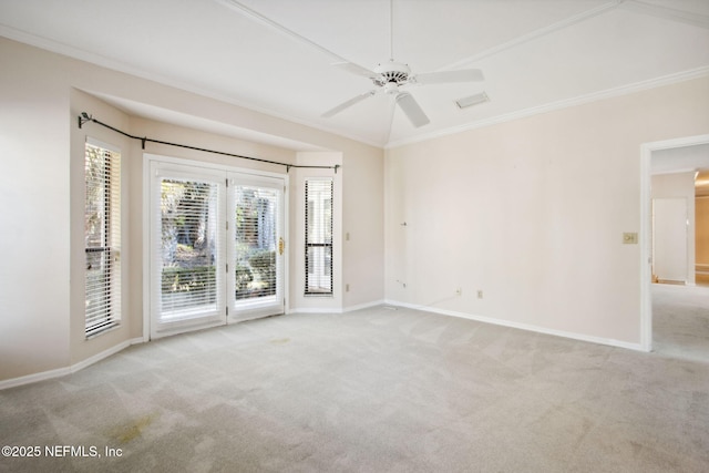 carpeted spare room featuring crown molding and ceiling fan