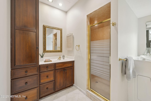 full bath featuring recessed lighting, vanity, baseboards, tile patterned floors, and a stall shower