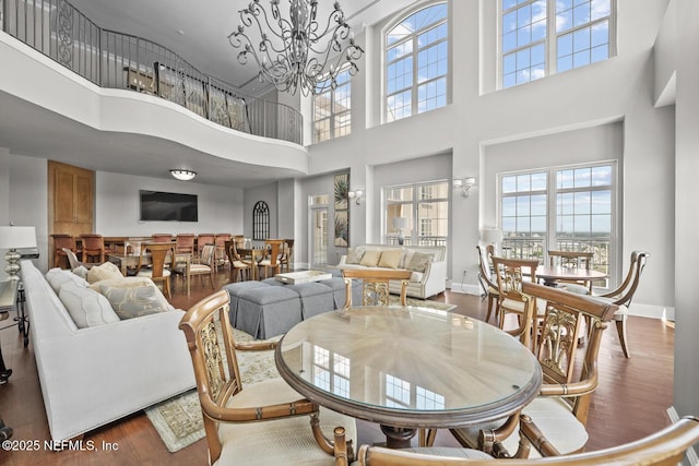 dining space with dark wood-type flooring and a notable chandelier