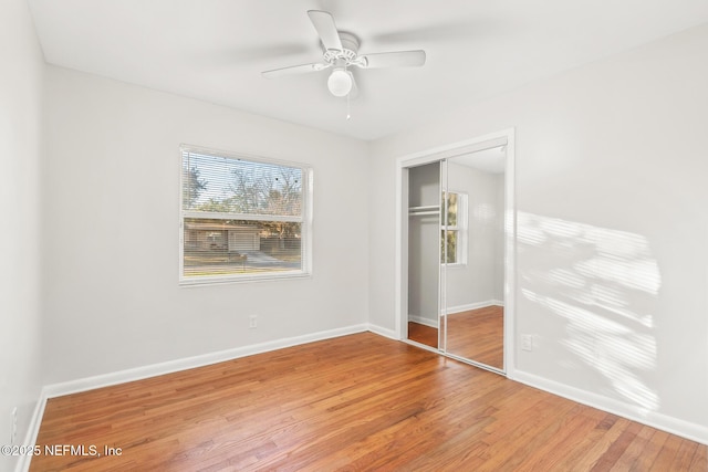 unfurnished bedroom featuring ceiling fan, hardwood / wood-style floors, and a closet