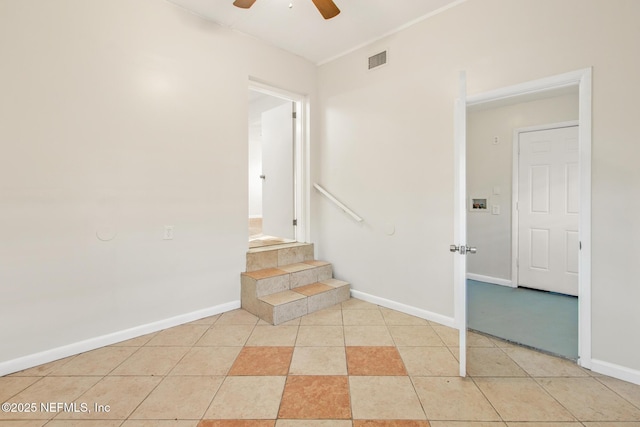 stairway featuring tile patterned flooring and ceiling fan