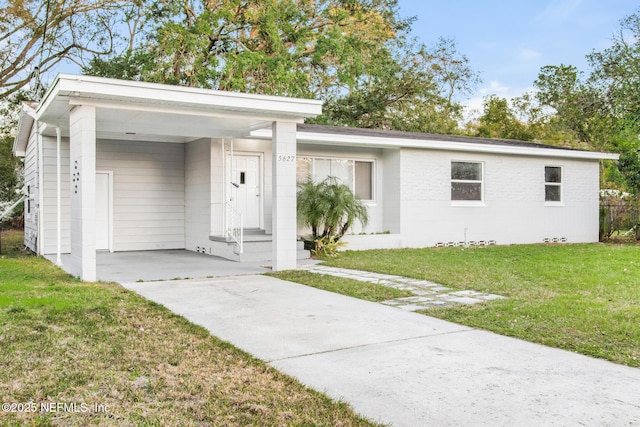 ranch-style home with a front yard and a carport