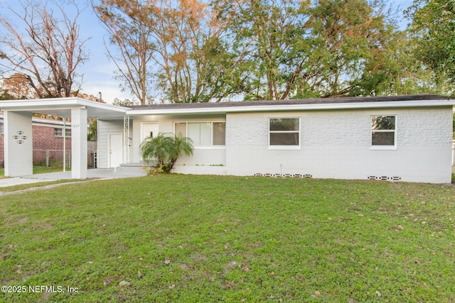 ranch-style house with a front lawn and a carport