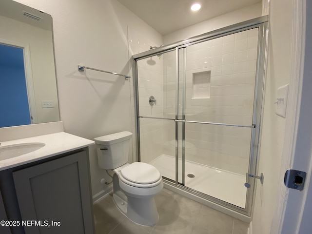 bathroom featuring vanity, toilet, and an enclosed shower