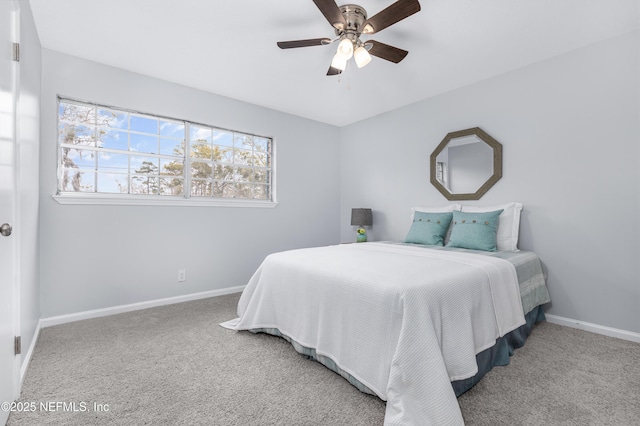 carpeted bedroom featuring baseboards and a ceiling fan