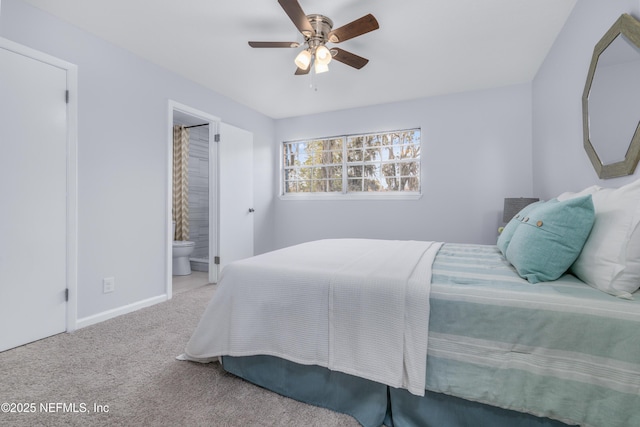 bedroom with ensuite bath, baseboards, ceiling fan, and carpet flooring