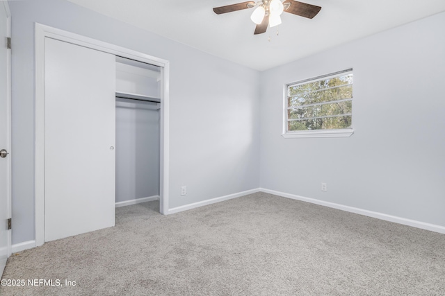 unfurnished bedroom featuring a ceiling fan, carpet, baseboards, and a closet