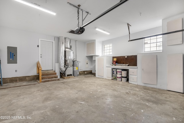 garage featuring electric panel, electric water heater, and a garage door opener