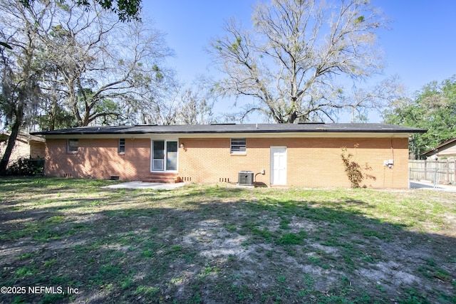 back of house with entry steps, central AC unit, fence, a yard, and crawl space