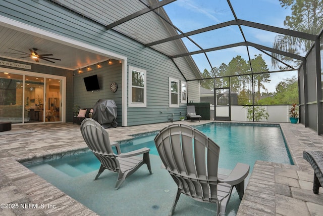 view of swimming pool featuring a lanai, ceiling fan, area for grilling, and a patio area