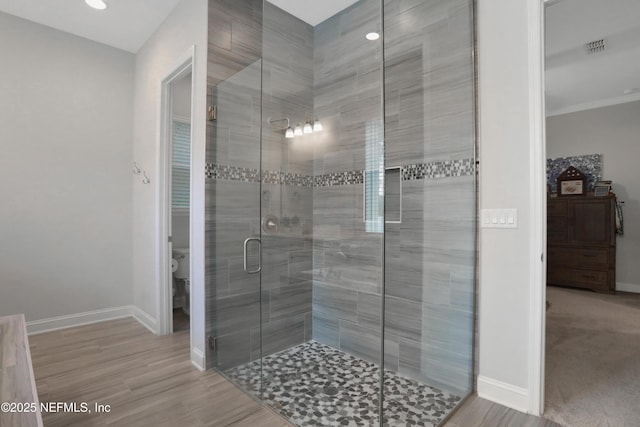 bathroom featuring an enclosed shower and toilet