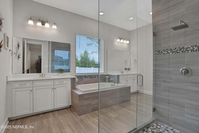 bathroom with independent shower and bath and vanity