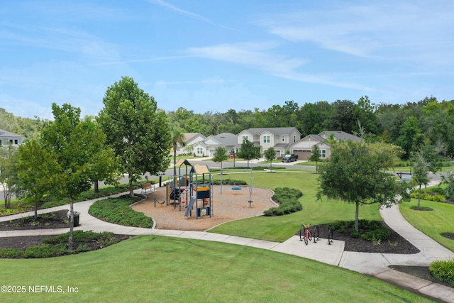 view of home's community featuring a yard and a playground