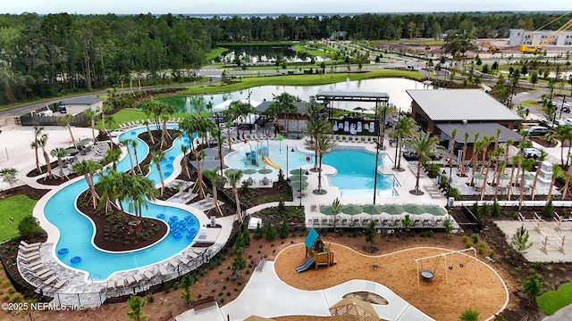 view of swimming pool featuring a water view